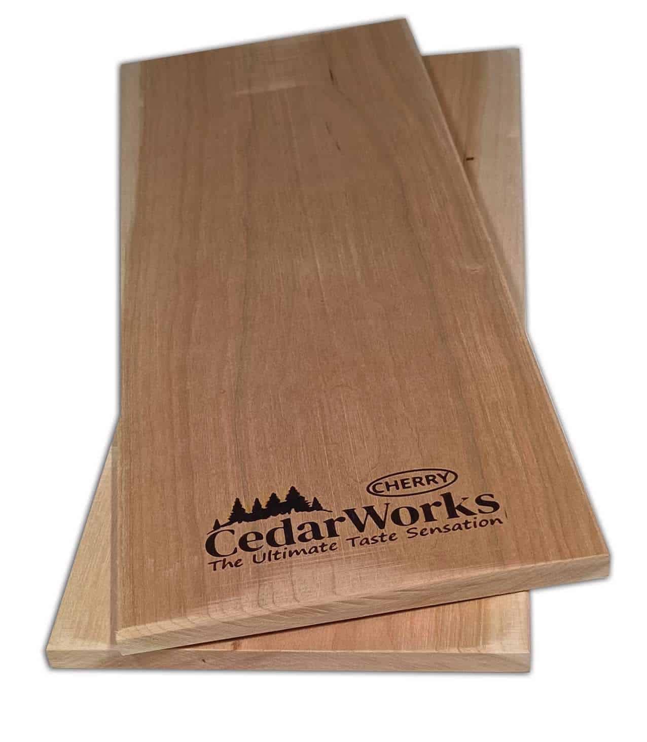 Handcrafted cedar woodworking chopping or serving boards with Cedar Works logo and Cherry wood branding, perfect for kitchen or serving purposes.