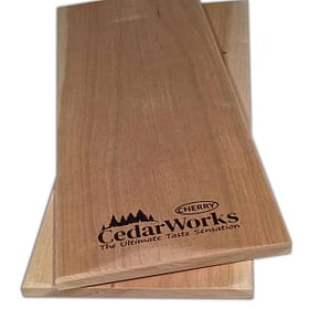 Handcrafted cedar woodworking chopping or serving boards with Cedar Works logo and Cherry wood branding, perfect for kitchen or serving purposes.
