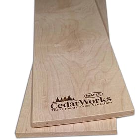 Solid maple wood cutting board with Cedar Works logo and natural wood grain. Perfect for kitchen prep, showcasing craftsmanship in high-quality timber products.