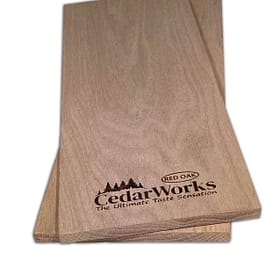 Elegant cedar wood sample with Cedar Works branding and Red Oak label, showcasing high-quality custom woodworking and craftsmanship.