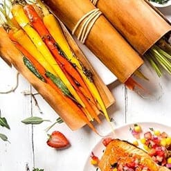 Colorful vegetable sticks wrapped in cedar leaf, ready for grilling or serving, showcasing sustainable, natural packaging.