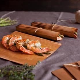Succulent shrimp and crayfish on a wooden serving board, with artisanal wooden tools nearby, showcasing cedar works craftsmanship and quality kitchen accessories.