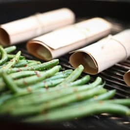 Fresh green asparagus being prepared with parchment paper, ideal for healthy cooking and gourmet dishes at Cedar Works.